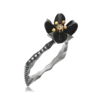 Oxidized sterling silver seed pod flower with a 2pt diamond