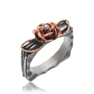 A 14kt rose gold rose with diamond on a square branch band