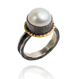 Round pearl set in oxidized silver and 18k gold