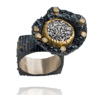 Black colored platinum ring with gold stones